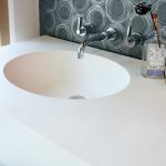 bathroom with white hanex solid surface countertop